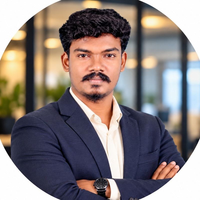 Mahesh Kumar Kanthaiya in a navy blazer, arms crossed